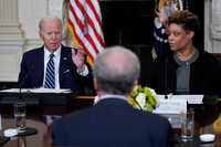President Joe Biden, left, sitting with Office of Management and Budget Director Shalanda Young, right, and Michael Horowitz, inspector general for the Department of Justice and chair of the Pandemic Response Accountability Committee, center, speaks during a meeting with Inspectors General in the State Dining Room of the White House in Washington, Friday, April 29, 2022. (AP Photo/Susan Walsh)